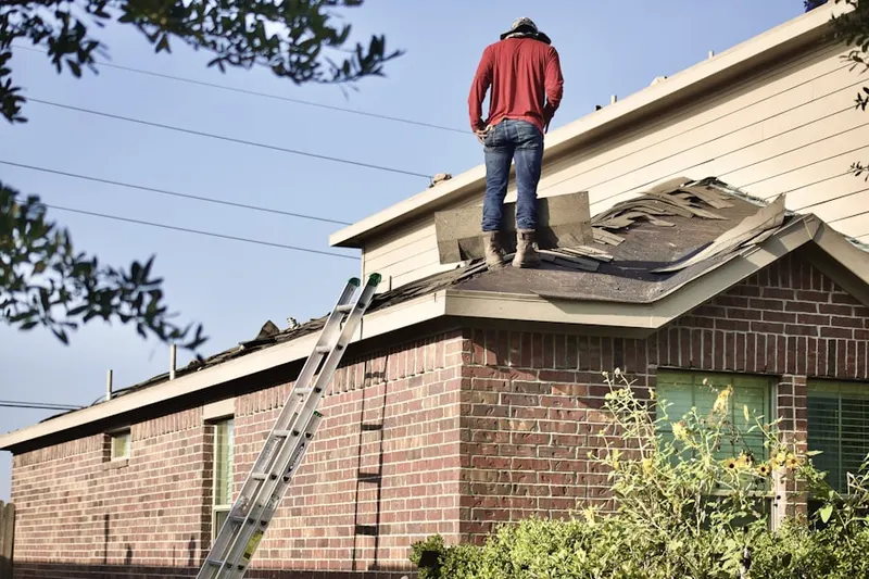 Professional roofer working on a residential roof in Romania